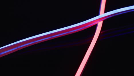 animation of pink neon lights over black background with copy space