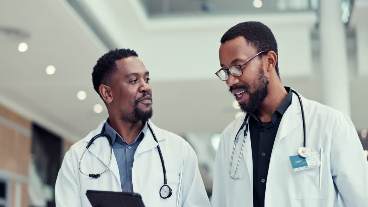 Doctors, tablet and talking in a hospital