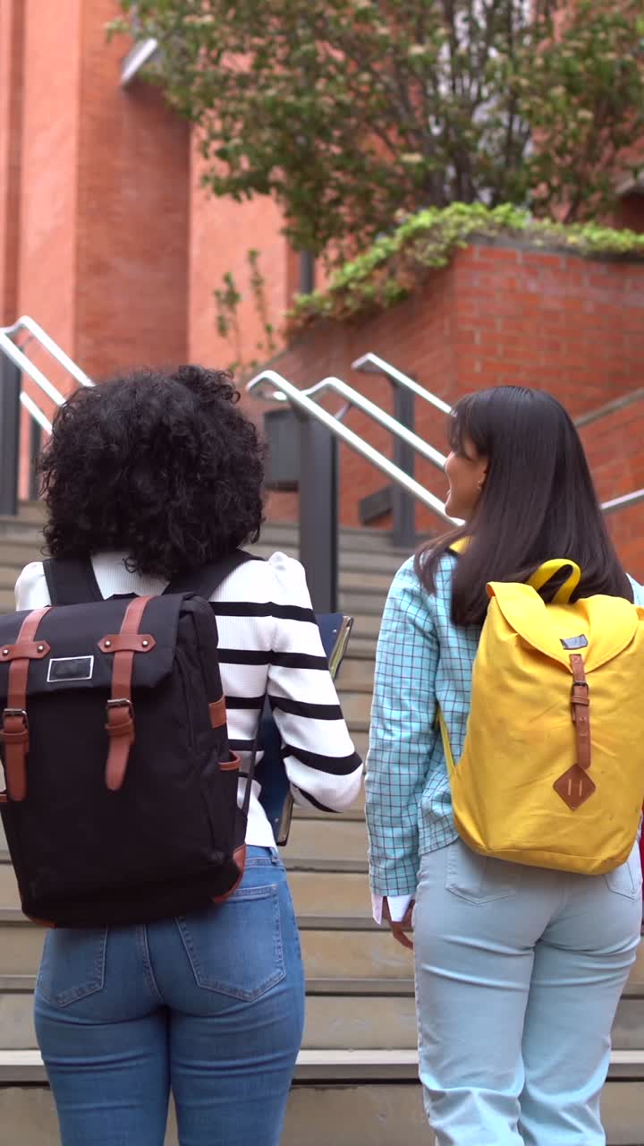Students walking up stairs with backpacks