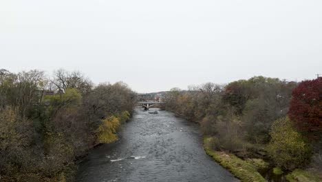 stone bridge crossing a dark fast river