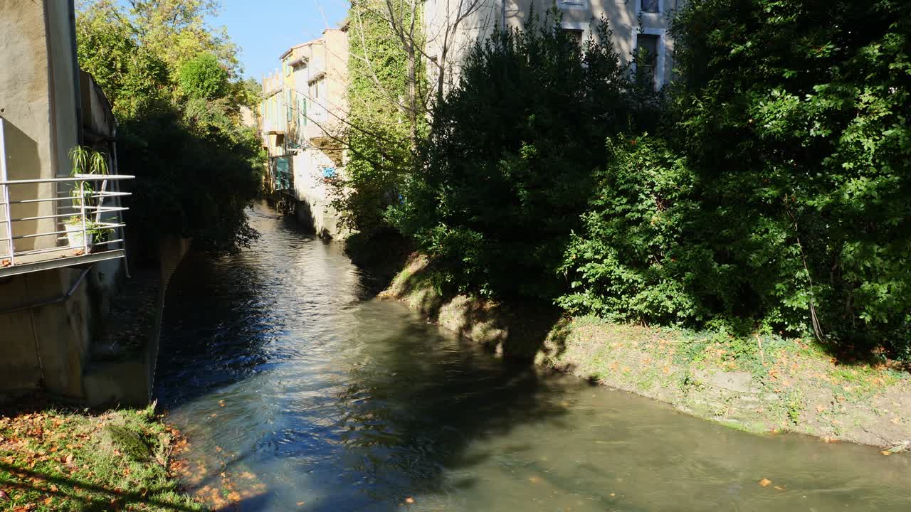 Static shot of La Meyne River crossing the town of Orange, France
