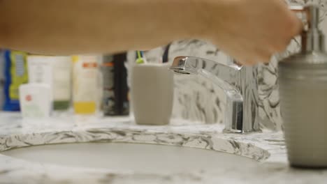 washing hands with soap and water in a washroom