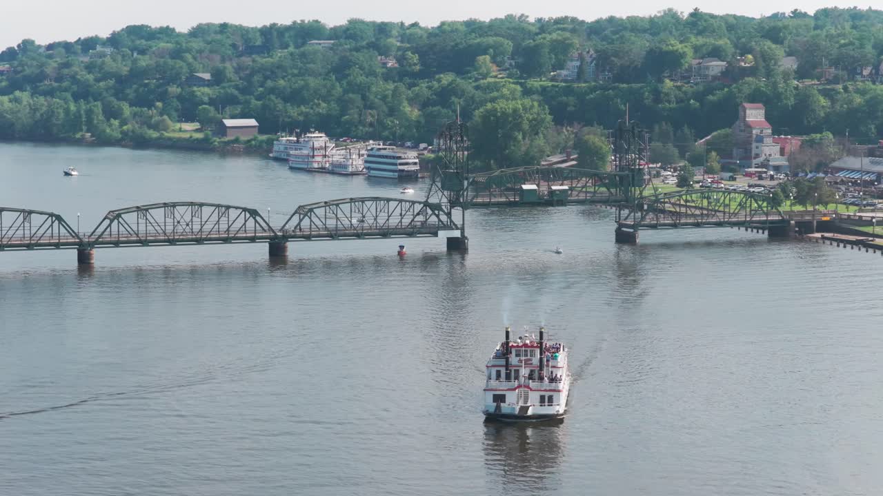 Telephoto close-up panning aerial shot of a riverboat on the St. Croix River near the lift bridge in Stillwater, Minnesota. 4K