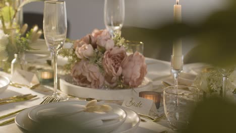 close up of table set for meal at wedding reception with place card for bride 3