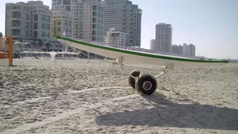 lifeguard surfboard parked next to beach lifeguard station ready for use