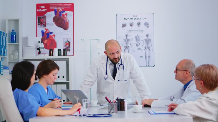 Professional doctor standing in front of colleagues presenting medical reports