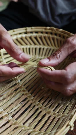 close-up of a person making a basket