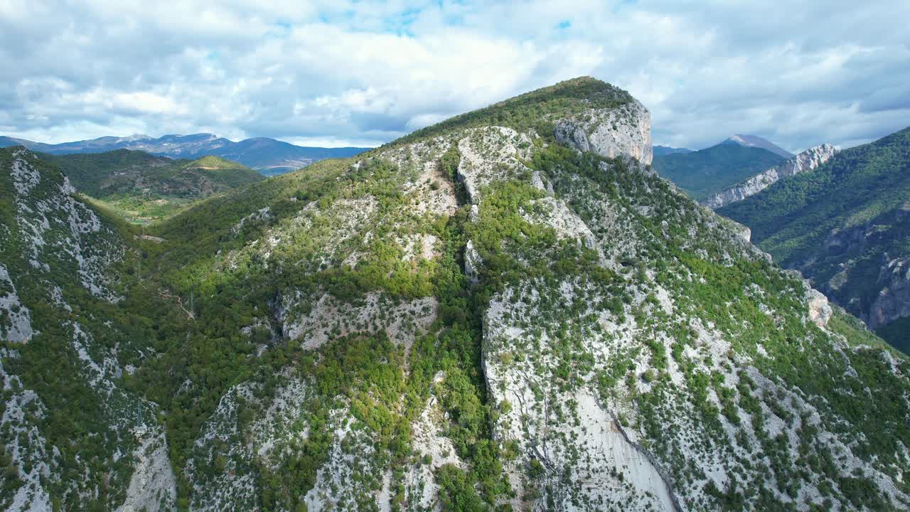 Panoramic shot (side pan) of the vast, forest-covered mountainous landscape in Kabashi, Albania. Represents nature, geography, and remote exploration