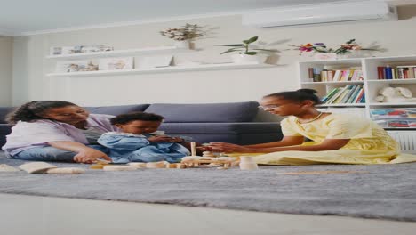 family playing with wooden blocks