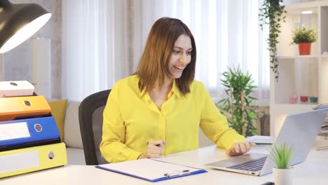 Young-woman-working-in-home-office-is-surprised-and-looking-at-camera-in-amazement.