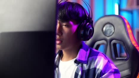 close up of asian teen boy gamer lose while playing video game on computer