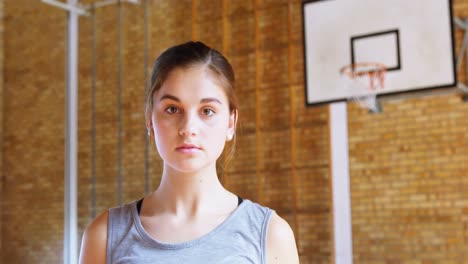 teenage girl holding a basket ball in the court 4k