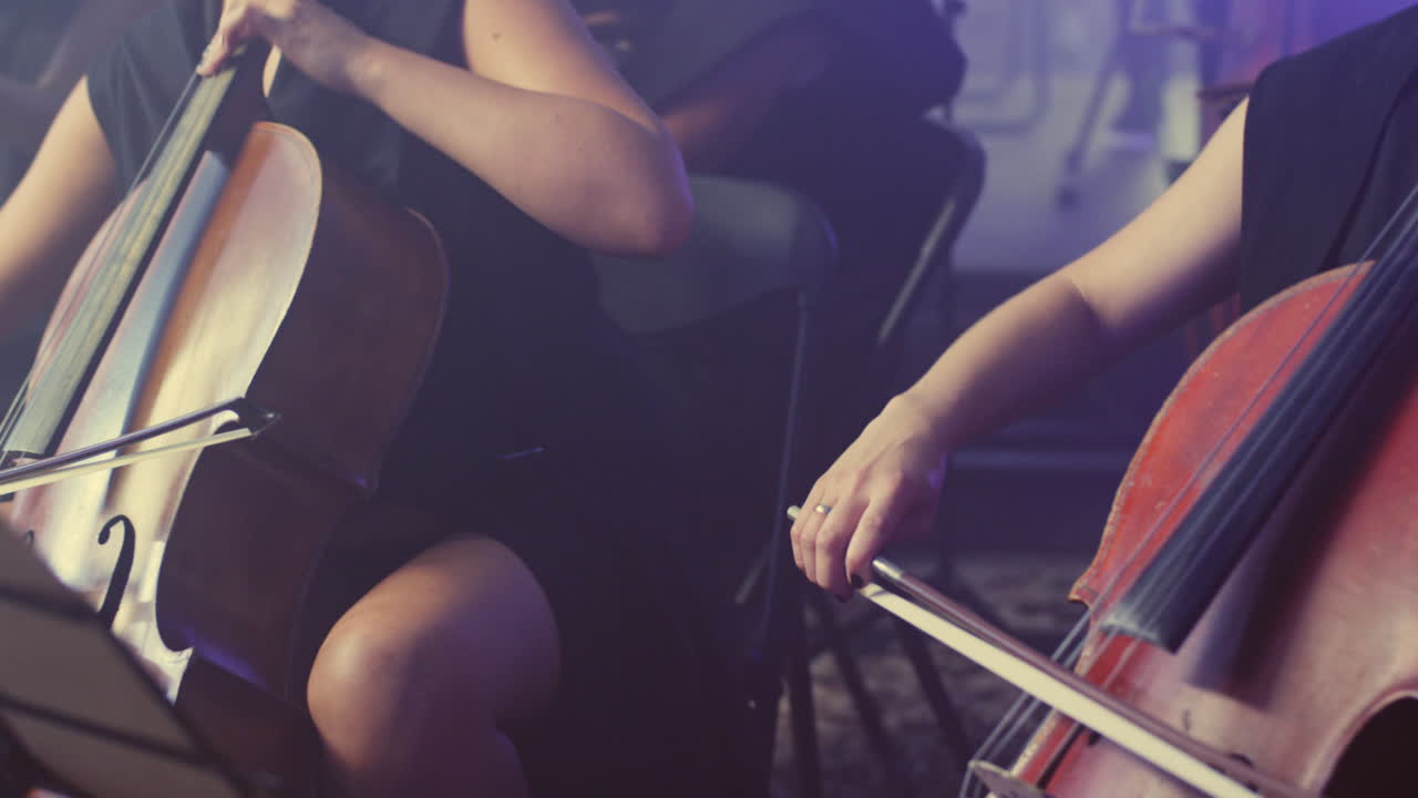 Female cello player playing violoncello. Woman hand playing cello