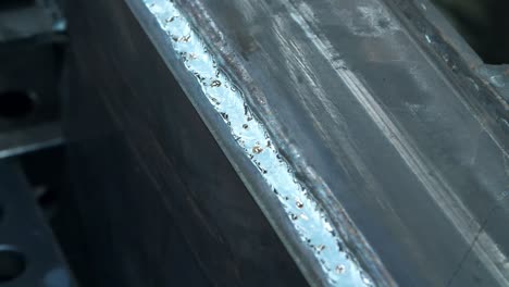 close up of metallic surface after weld influence. iron with traces of welding