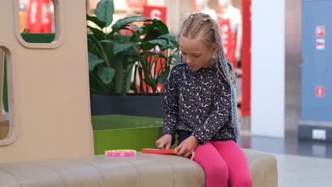 Girl Plays with Silicone Fidget Toys in Mall
