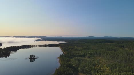 misty landscape in dalarna, sweden in the afternoon - aerial shot