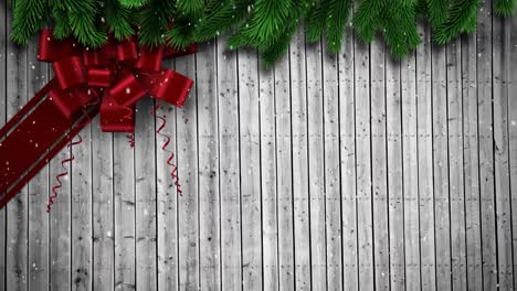 animation of christmas red bow over wooden background