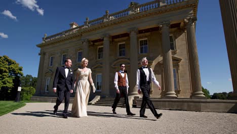 vintage style people walking in front of a mansion