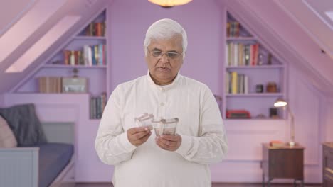 Indian-old-man-counting-money