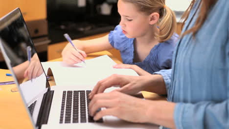 Little-girl-drawing-on-her-notebook