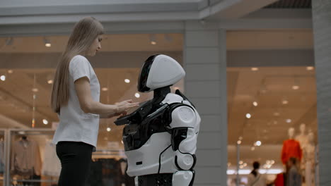 the robot looks at the girl. artificial intelligence. modern robotic technologies. the robot looks at the girl with enamored eyes. modern robotic technologies