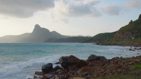 Dreamy-shot-of-waves-crashing-into-rochy-beach-in-Con-Dao-Island,-Vietnam