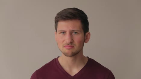 young male model facing camera and showing disgust and negation, medium close-up still shot