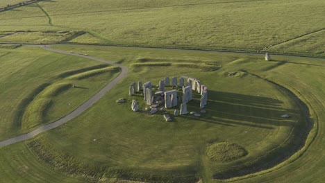 stonehenge, green fields and shadows from above with a warm summery feeling