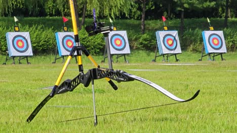 Archery-Recurve-Bow-With-Row-Of-Target-Board-In-The-Background