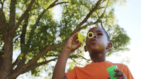 Young-boy-blowing-bubbles-through-bubble-wand