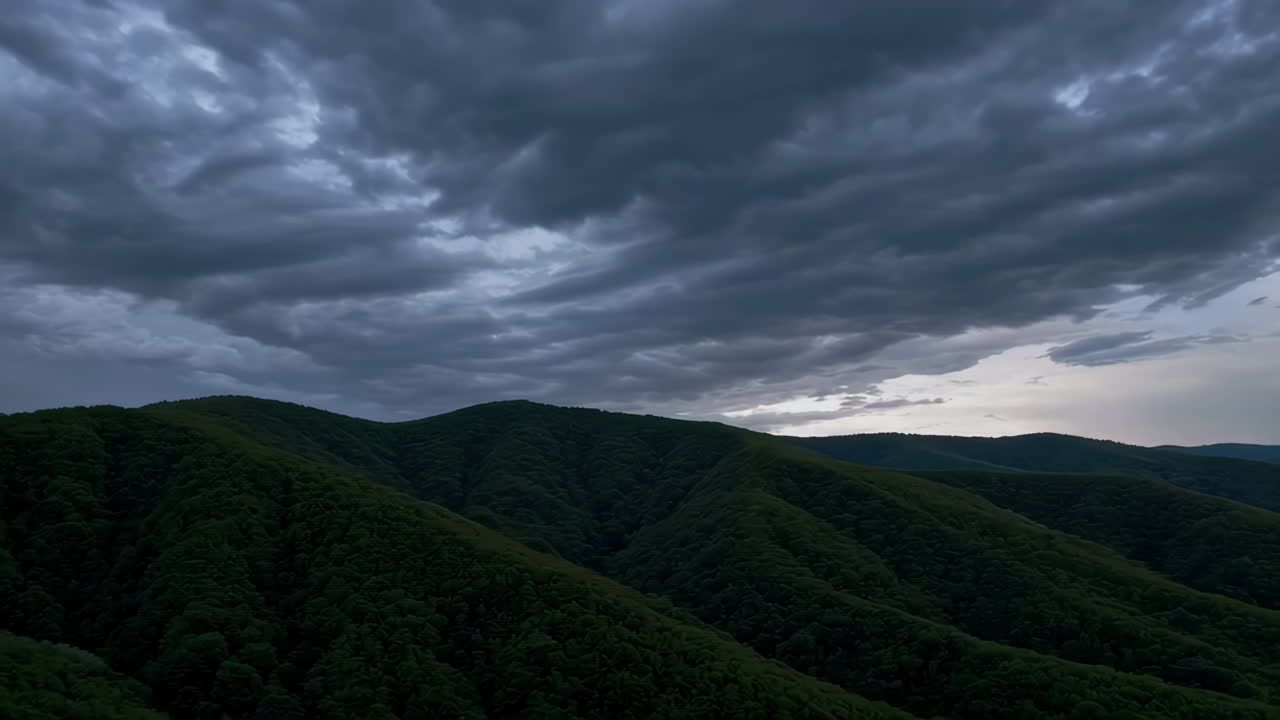Mountainous Landscape Under Stormy Sky