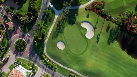 Drone-aerial-view-looking-down-at-a-perfectly-curated-golf-course-putting-green