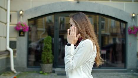 disappointed business woman arguing by mobile phone outdoors