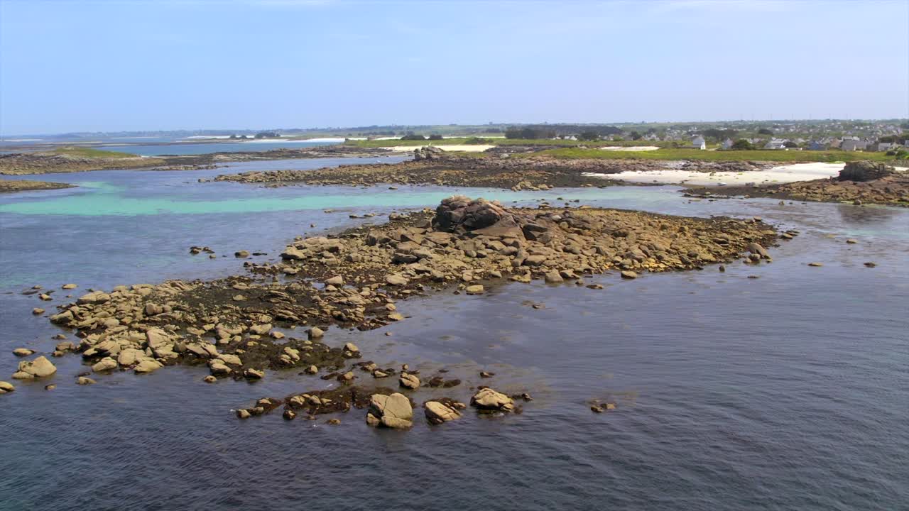 French Atlantic near Brest, Brittany, showcasing a rocky shoreline and vivid blue-green tidal waters. This coastal seascape highlights the natural beauty of Brittany’s rugged shoreline. Drone aerial.