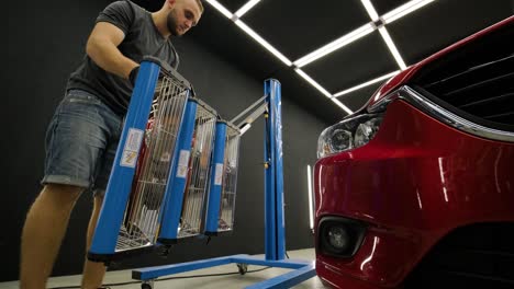 red lamps for drying the ceramic coating are behind car