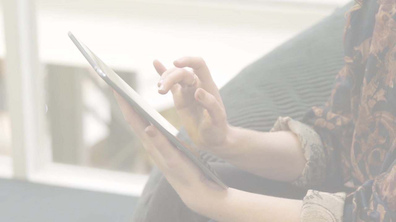 Woman tapping tablet, swiping and scrolling, navigating tech interface, green scanlines overlaying