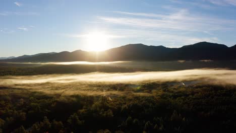 sunrise over mountains during peak foliage season in new england