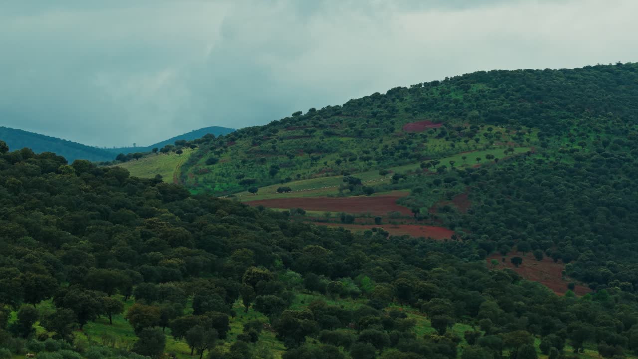 Slowmotion drone shot over forest mountains in cloudy portugal
