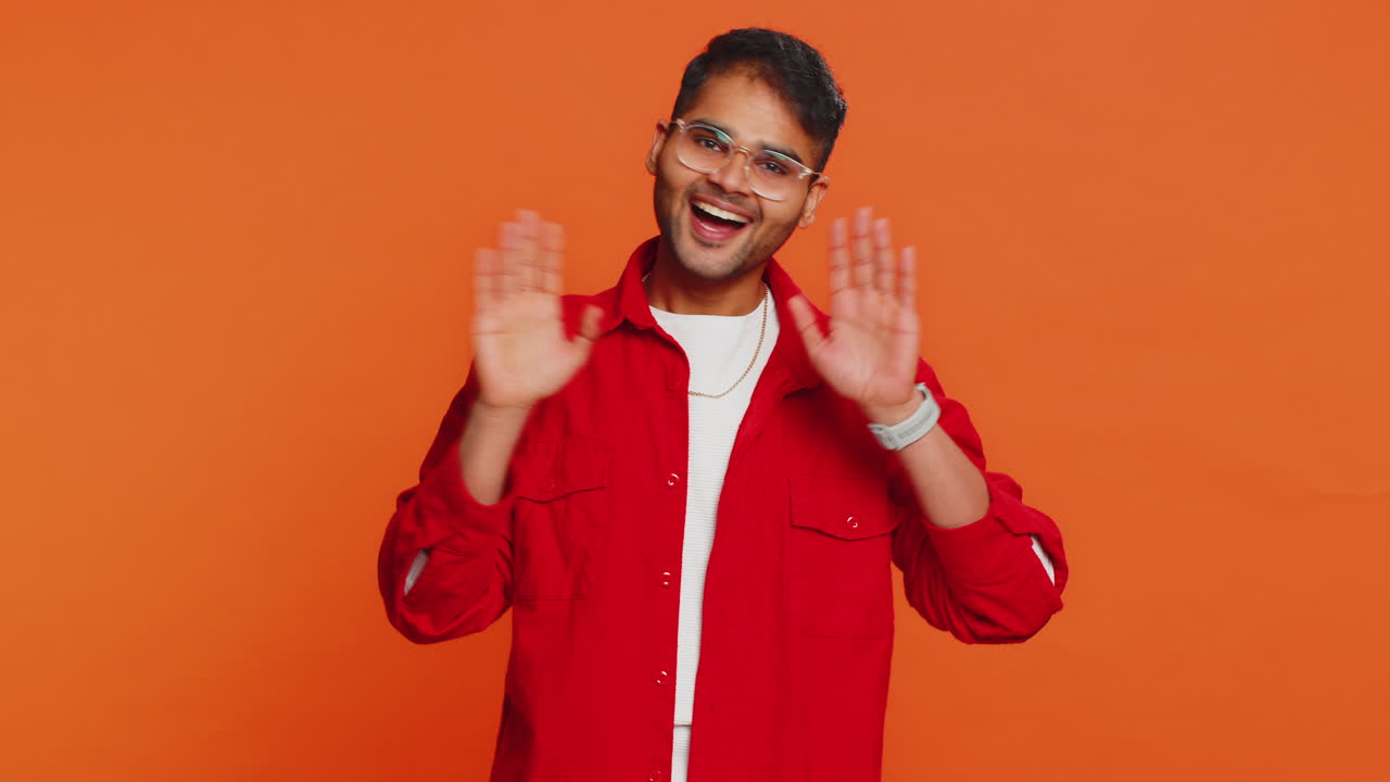 Happy man smiling friendly waving hands gesturing hello greeting or goodbye meeting invitation