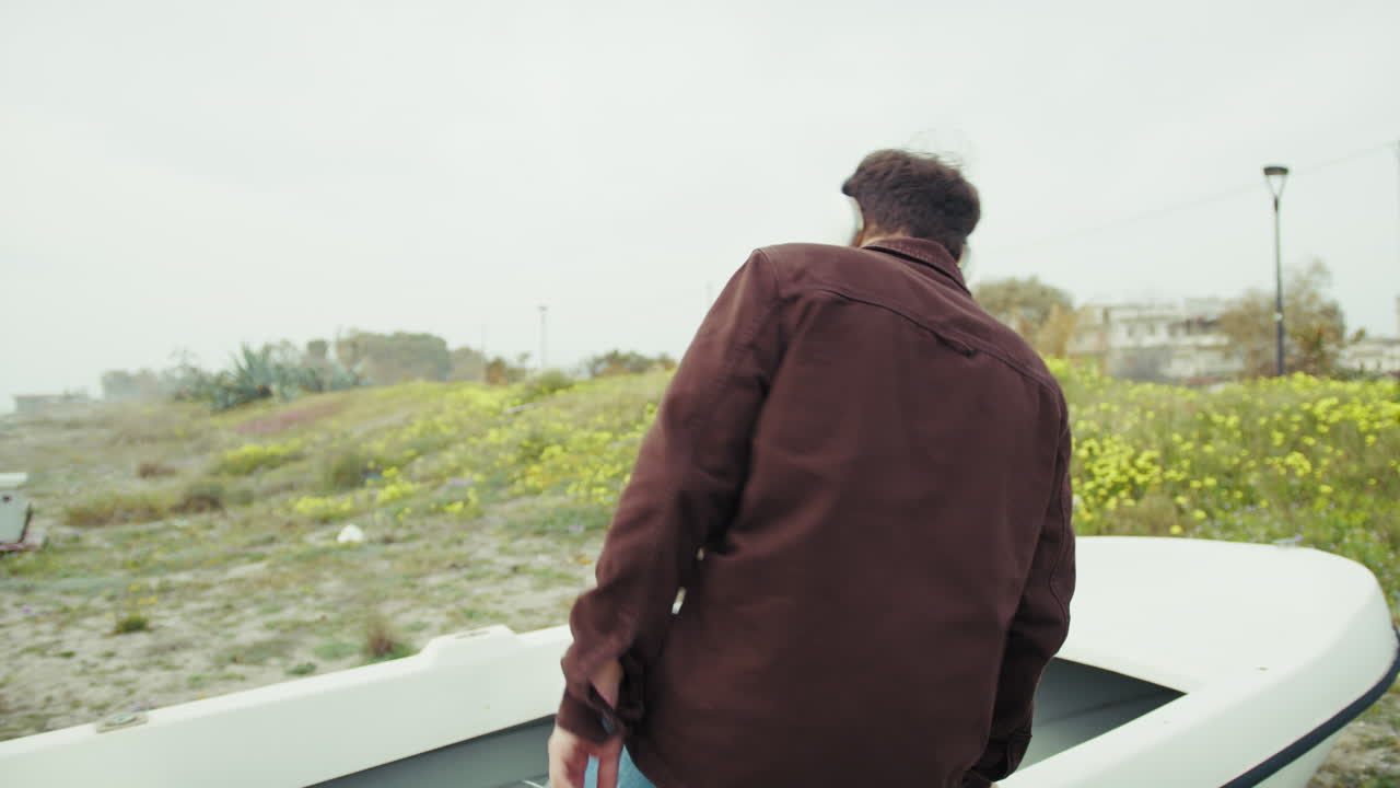 Man On The Beach Dancing To The Music With Headphones