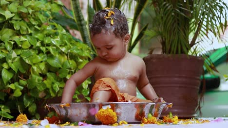 cute toddler baby boy bathing with shampoo in decorated bathtub at outdoor from unique perspective