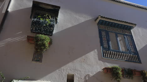 traditional arabic architecture in a historic tunisian city with ornate windows and sunlit walls