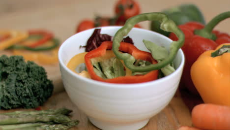 peppers falling into bowl in super slow motion