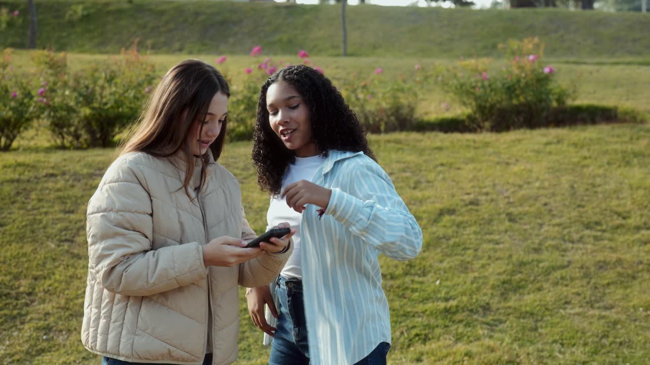 Teenage Friends Taking Selfies in a Park