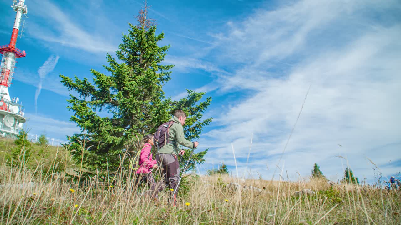 People hiking near a mountain tower