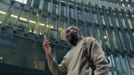 man using smartphone in city