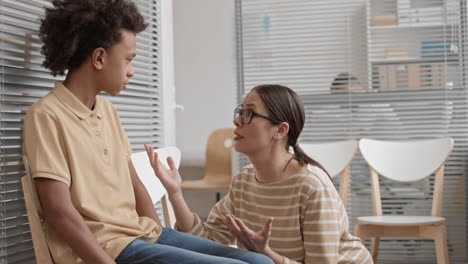 caucasian mother reassuring african son