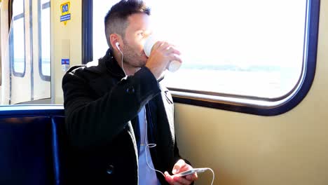 businessman listening to music while having coffee