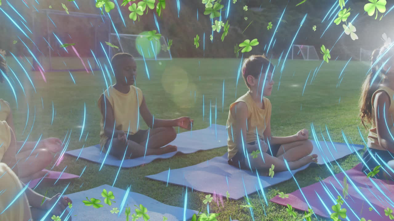 Children meditating outdoors with clover and light streaks animation overlay