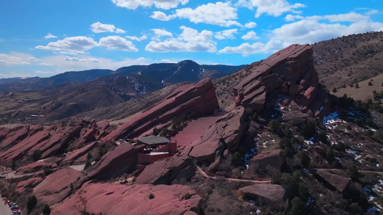 Red Rocks Park and Amphitheater Mount Morrison Colorado aerial drone mid winter music stage snow covered walking trails Trading Post sunny blue sky clouds stairs tourist destination circle left